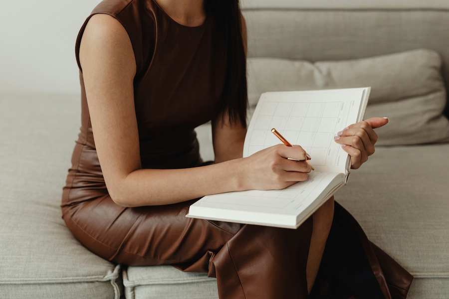 woman writing in planner